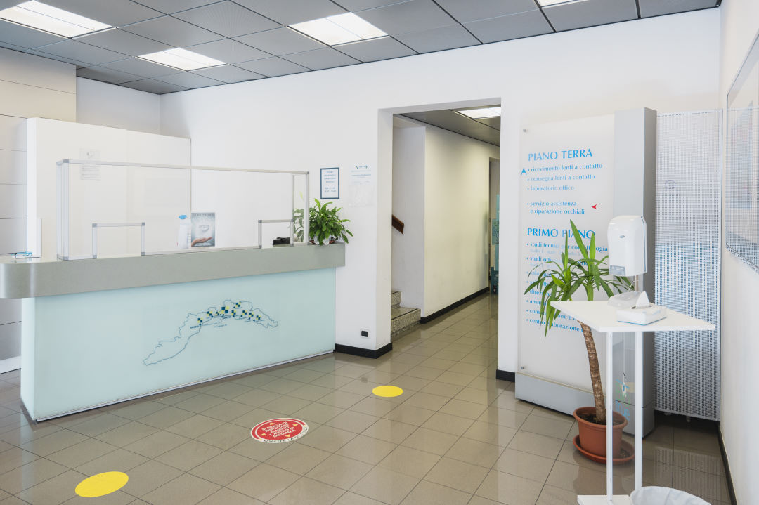 Reception area with plants and informative signs.